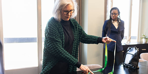 Prof Michele Ramsay and the bead necklace created from data denoting genetic ancestry, with Jocelyne Gayenga 600x300